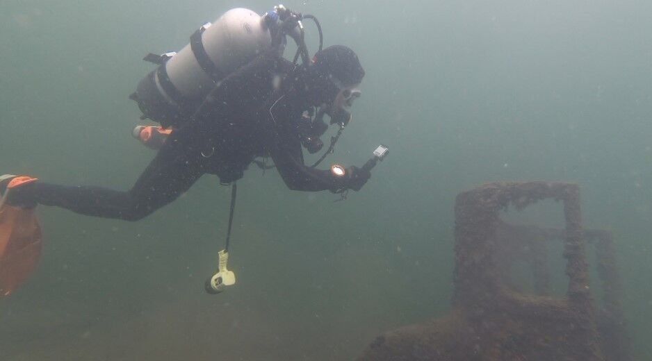 A diver examines an underwater car in Lake Mendota